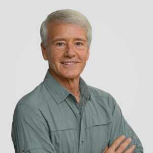 portrait of Randy, arms crossed in a green shirt.