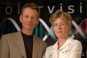 A photo of Jay and Maureen Neitz, standing together in their lab.